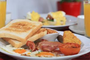 a plate of breakfast food with eggs bacon and toast at Route 66 Motor Inn in Emerald