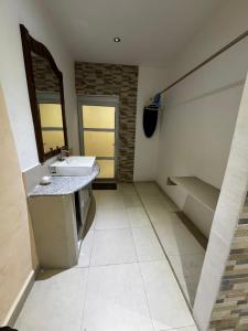 a bathroom with a sink and a mirror at Casa Enna in Isla Mujeres +41 photos