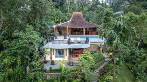 an aerial view of a house in the forest at Yoga Maya Villa in Gianyar