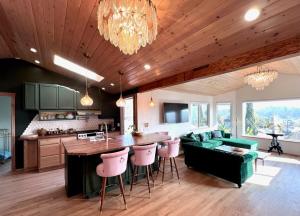 a kitchen and living room with a couch and a table at The Perch- Hilltop Bungalow, Eagle Rock-near DTLA in Los Angeles