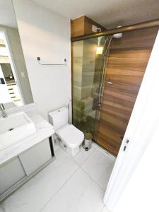 a bathroom with a toilet and a sink and a shower at Unity, Cabo Branco Flat 324 in João Pessoa
