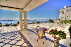 un patio con mesa, sillas y agua en Cunda Kivrak Hotel, en Ayvalık