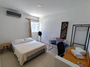 Un dormitorio con una cama y una mesa y sillas. en Apartamento Vacacional Rodadero, en Gaira
