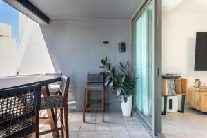 a room with a table and a potted plant at Private CBD Bedroom in a Shared Apartment on Brisbane River in Brisbane