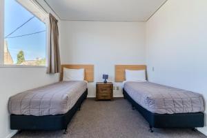 Voodi või voodid majutusasutuse George Street Motel Apartments toas