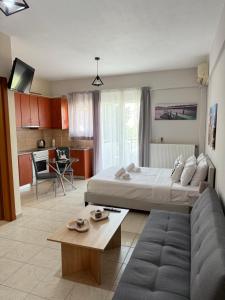 a living room with a large bed and a couch at Gerapetros 82 in Ierapetra