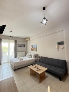 a living room with a couch and a bed at Gerapetros 82 in Ierapetra