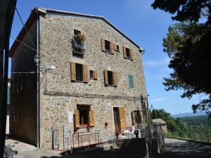 an old stone building with a flower box on it at Charmante Home with Garden in San Valentino