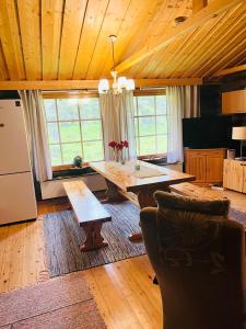a large living room with a table and chairs at Villa Karhunkehto in Luosto
