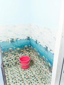 a painting of penguins in a wall with a bucket at INN Shyam Bihari Guest House 500 Meter Ram mandi in Ayodhya
