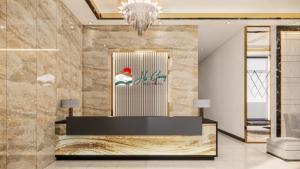a lobby with a reception desk and a chandelier at Ha Giang Hill Hotel in Dồng Văn