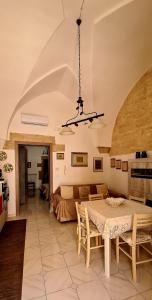 a living room with a table and a couch at Via Cufra 46 in Botrugno