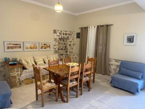 a living room with a table and chairs and a couch at Kalymnos Beach House in Kalymnos