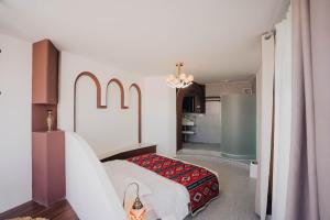 a bedroom with a bed with a red blanket at 一千零一夜喀什古城民宿 Kashgar Ancient City Scenic Area in Kashgar