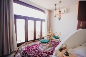 a room with two chairs and a table in front of a window at 一千零一夜喀什古城民宿 Kashgar Ancient City Scenic Area in Kashgar