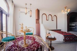 a bedroom with a bed and a table and chairs at 一千零一夜喀什古城民宿 Kashgar Ancient City Scenic Area in Kashgar