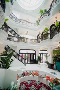 a living room with a spiral staircase and a couch at 一千零一夜喀什古城民宿 Kashgar Ancient City Scenic Area in Kashgar