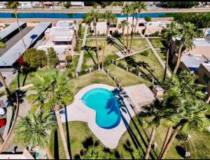 an aerial view of a resort with a pool and palm trees at Cozy Condo in Yuma