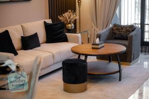 a living room with a couch and a table at Fabulous Brand New 1BR in Ras al Khaimah