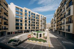 a truck parked in a parking lot in front of buildings at Fabulous Brand New 1BR in Ras al Khaimah