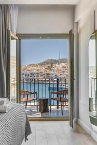 a bedroom with a view of the water at Eclectic Syros in Ermoupoli