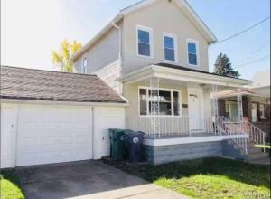 a white house with a garage in front of it at Niagara View at LaSalle SH in Niagara Falls