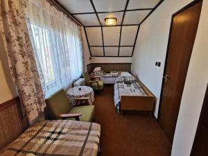a small room with two beds and a window at Herbaheal Villa in Balatonkeresztúr