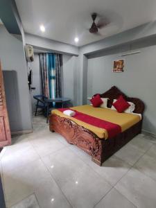 a bedroom with a large bed with red pillows at Villa Victor in Puducherry