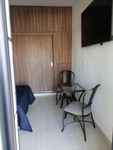 a room with two chairs and a table and a door at Casita con casa club in La Paz +9 photos