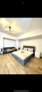 a bedroom with a large bed and a ceiling at Apartamente & Studiouri Melia Eforie Nord in Eforie Nord
