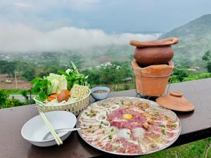 a table with a plate of food on it at Heaven Khaokho (เฮฟเว่น) in Khao Kho
