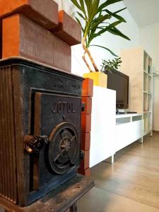 a woodburning stove in a living room with a tv at Cozy 1-bedroom apartment with free parking in Rīga