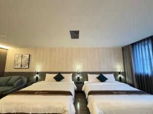 Postel nebo postele na pokoji v ubytování Hualien Pink Corner Hotel