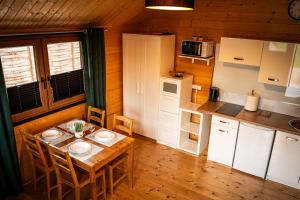 a kitchen with a table with two plates on it at Relax domki Zator in Zator
