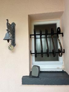 a window with a bell on the side of a building at Chambre avec vue sur le marais et la piscine in Yves