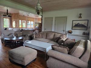 a living room with couches and a coffee table at Beach house La Toolse vita with sauna in Toolse +66 photos