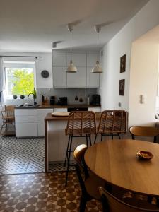 a kitchen and dining room with a table and chairs at Apartamenty Okrętowa 23 Bolek Lolek in Bielsko-Biala