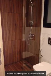 a shower with a glass door in a bathroom at Superbe S2 richement meuble Marsa in Sidi Daoud