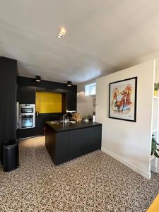 a kitchen with a sink and a counter at La Villa Convivium - Chambres privées in Rouen