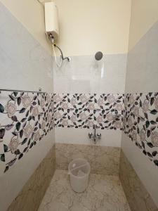 a bathroom with a toilet with a bucket in it at Rio Grande ApartHotel in Madurai +23 photos