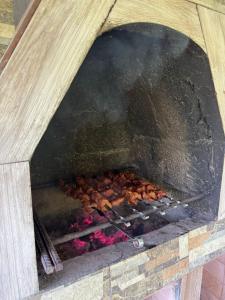a grill with a bunch of food cooking at Mountain paradise in Merisi in Merisi