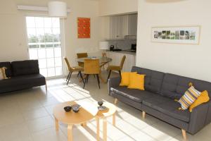 a living room with a couch and a table at Kalamata 360 View in Kalamata