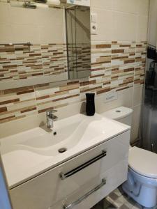a bathroom with a sink and a toilet at Maisonnette au pied du marché et 300 m de la plage in Saint-Georges-de-Didonne
