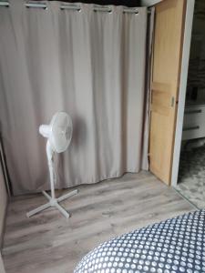a bedroom with a shower curtain and a fan at Maisonnette au pied du marché et 300 m de la plage in Saint-Georges-de-Didonne +21 photos