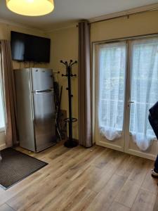 a living room with a refrigerator and a window at Maisonnette au pied du marché et 300 m de la plage in Saint-Georges-de-Didonne