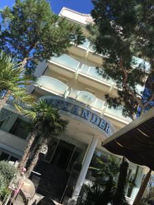 a building with a sign that reads hotel at Hotel Alexander in Milano Marittima