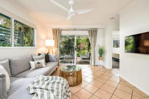 a living room with a couch and a table at Trinity Escape - Marlin Cove Resort - Trinity Beach in Trinity Beach