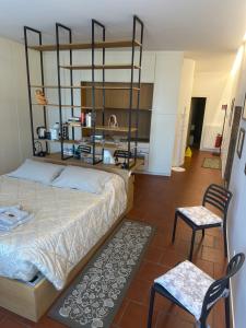 a bedroom with a large bed and two chairs at La Suite del Doge - Parking in Treviso +20 photos