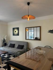 ein Wohnzimmer mit Tisch und Couch in der Unterkunft Maison T4 plain pied climatisée avec une belle terrasse ombragée 6AVR44 in Canet-en-Roussillon + 34 Fotos