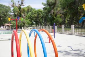 a row of colorful playground equipment in a park at Soledad Canyon Deluxe Cabin 23 in Ravenna +13 photos